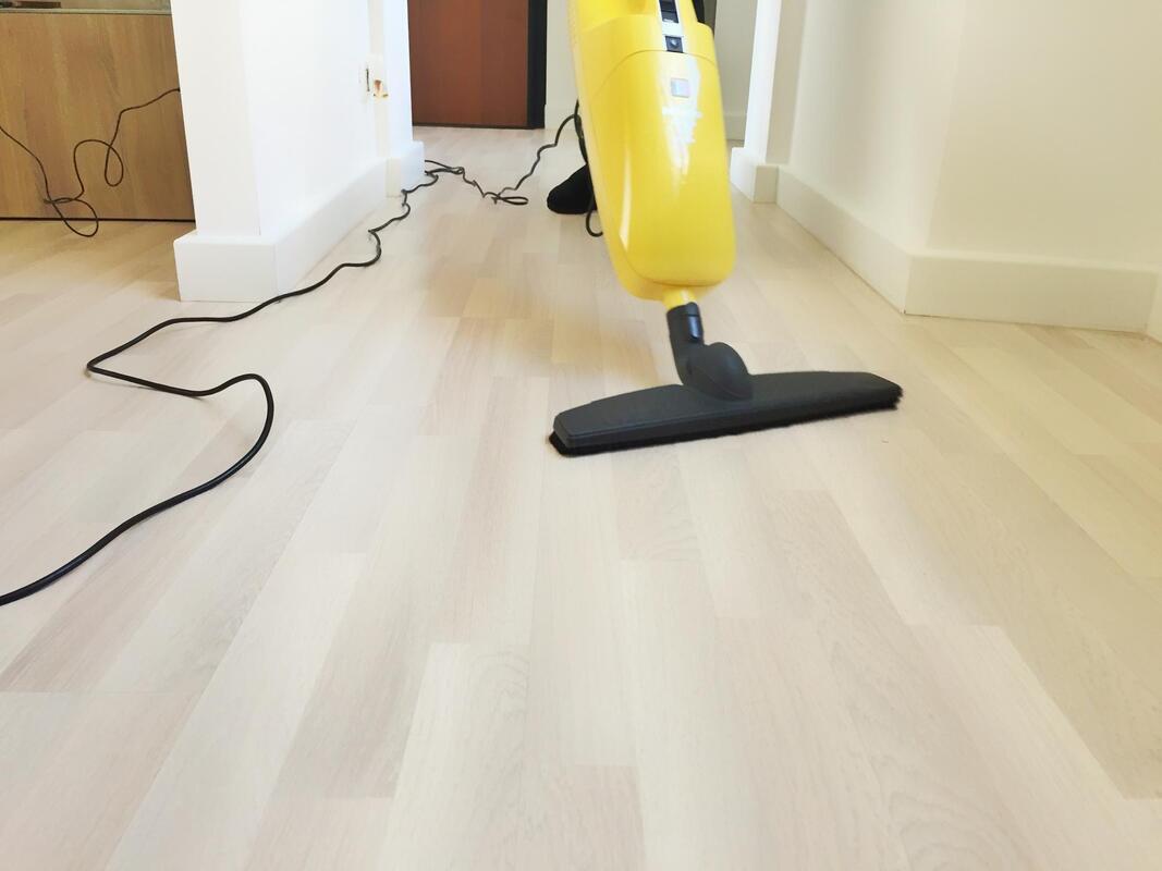 vacuuming the hardwood floor
