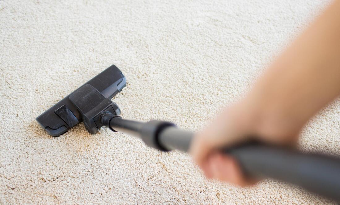 lady vacuums the carpet